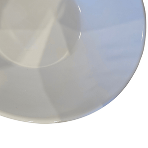 Close-up of a white ceramic plate on a white background