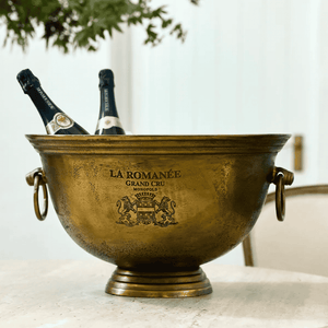 La Romanée Ice Bucket in antique gold styled on a French dining table