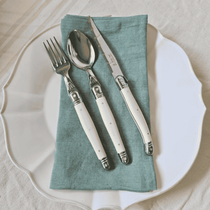 Provence Mint Linen Napkins folded on a white Vienna Dinner Plate with Laguiole cutlery
