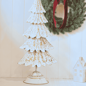 Close-up of embossed gold detailing on tiered metal Christmas tree Base