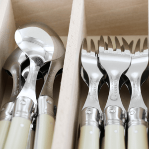 Close up of Spoons and Forks from Laguiole Debutant cutlery set in ivory – authentic French dining set – Malmaison
