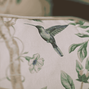 Close-up of a fabric with a green hummingbird design on a beige background