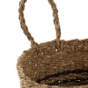 Close-up of natural seagrass weave and striped detailing on basket
