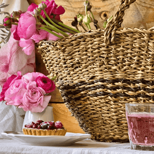 French Riviera Tote styled on a French country table with flowers and rosé