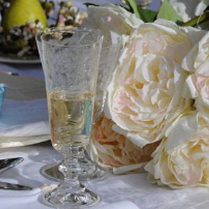 Elegant champagne flutes in use during French-inspired celebration