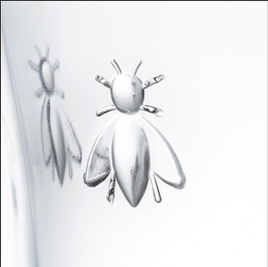Close up image of bee emblem on wine glass goblet