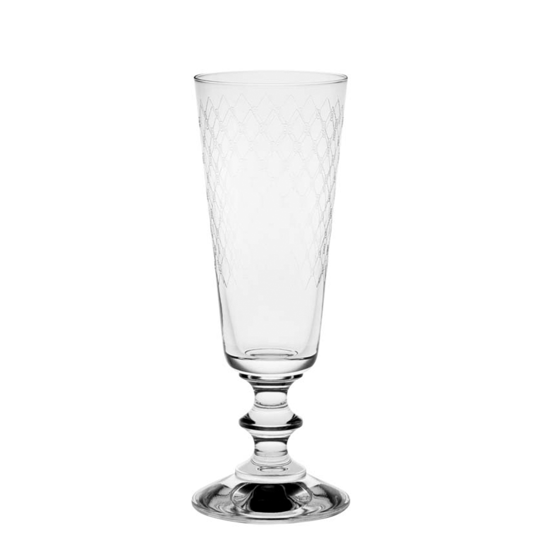 A set of four etched crystal champagne flutes with fishnet patterns, displayed alongside a wooden storage box and a broom, on a table with a floral fabric.