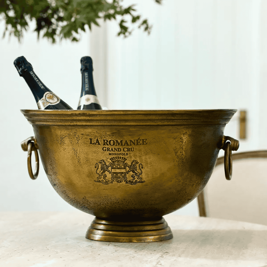 La Romanée Ice Bucket in antique gold styled on a French dining table