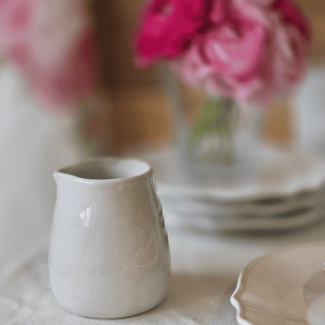 Milk Jug or Creamer with Flowers in background