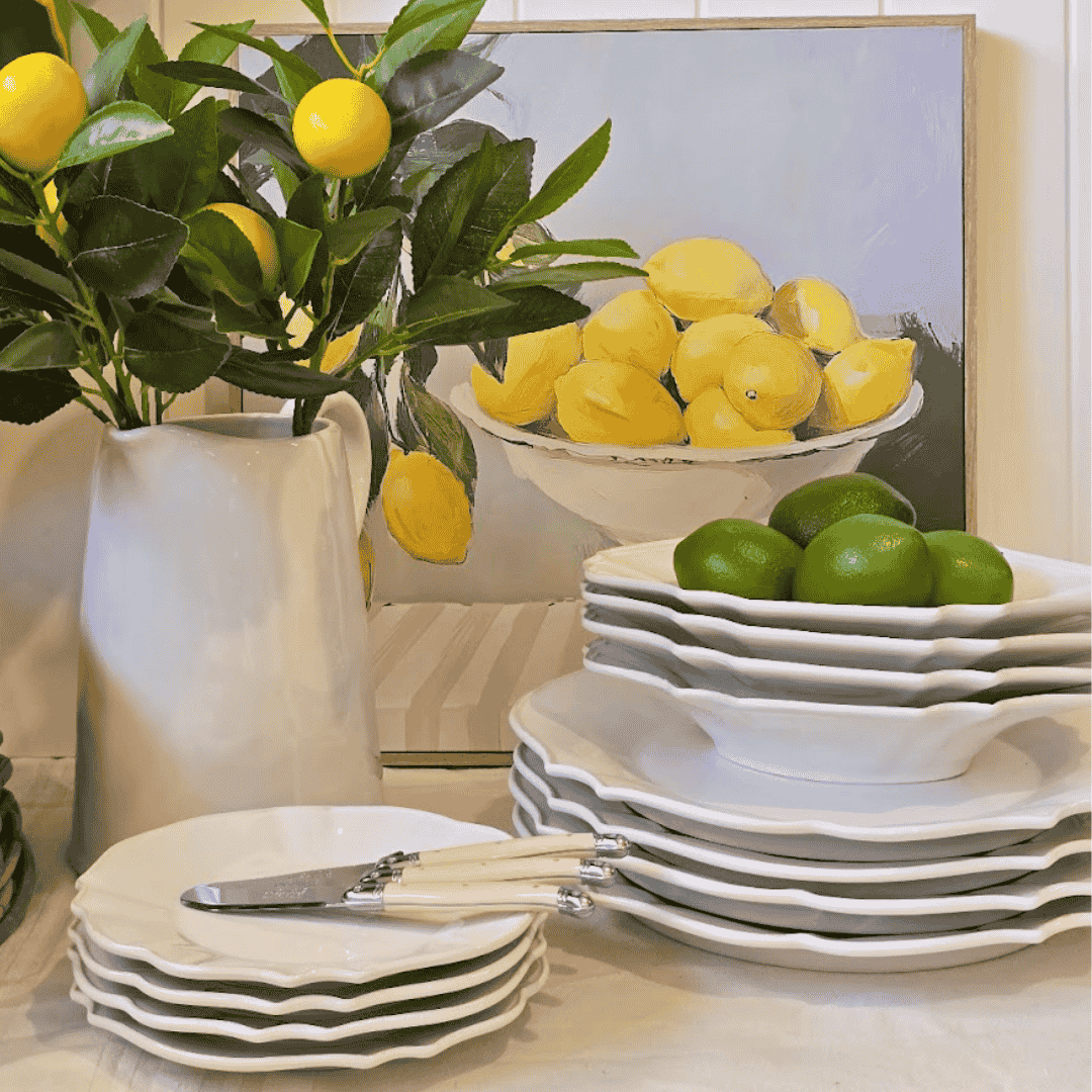 French Country Vienna White Stoneware Dinnerset with lemons and limes on a table