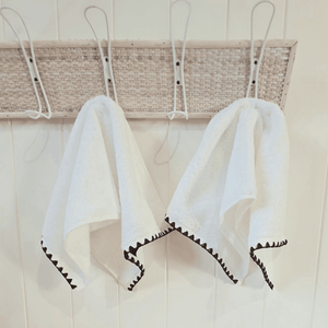 Issey French Hand Towel hanging on hooks