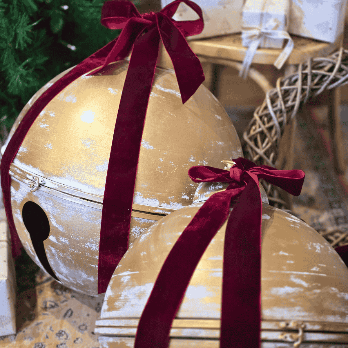 Decorative gold Christmas Bells with velvet red ribbons in a festive setting