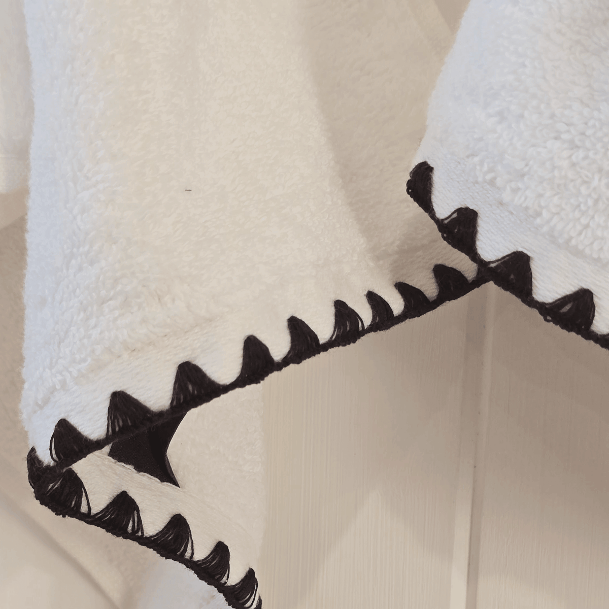 French hand towel hanging with black trim