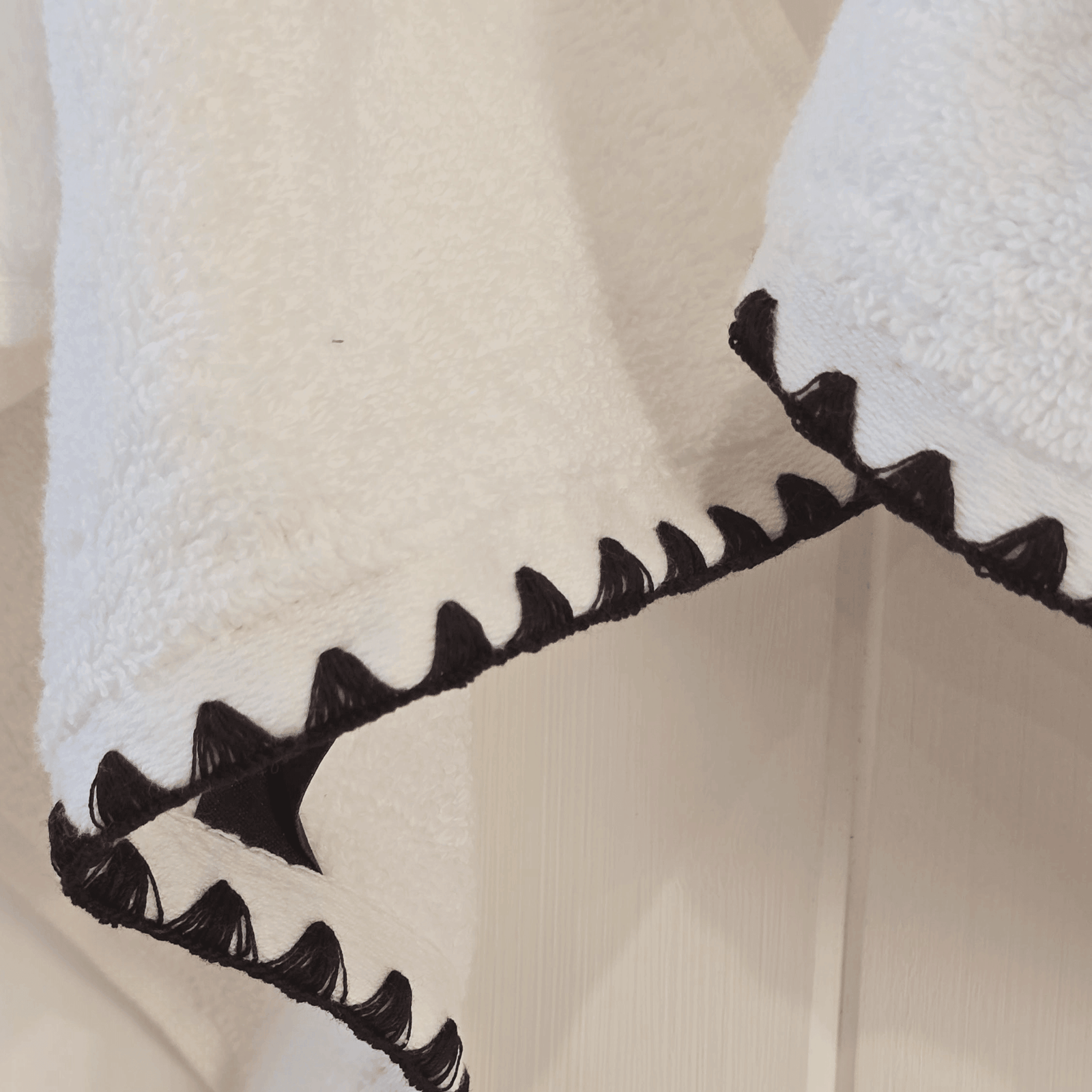 Issey French Hand Towel hanging on hooks