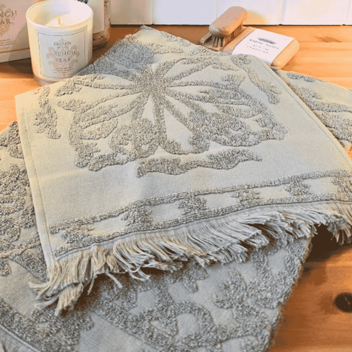 Textured towel with leaf pattern on a wooden surface