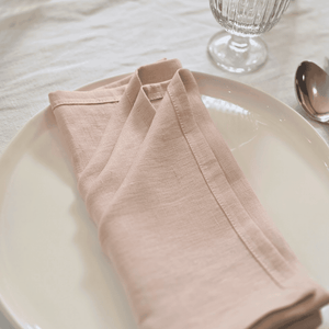 Close-up of blush pink linen texture showing fine weave