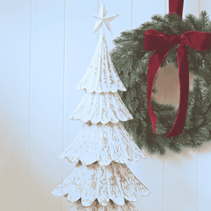 Close-up of embossed gold detailing on tiered metal Christmas tree