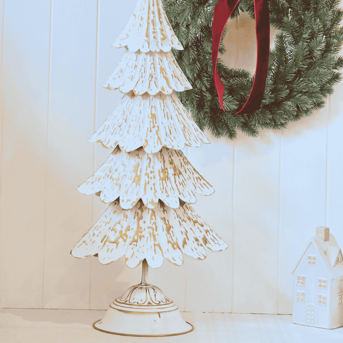 Close-up of embossed gold detailing on tiered metal Christmas tree Base