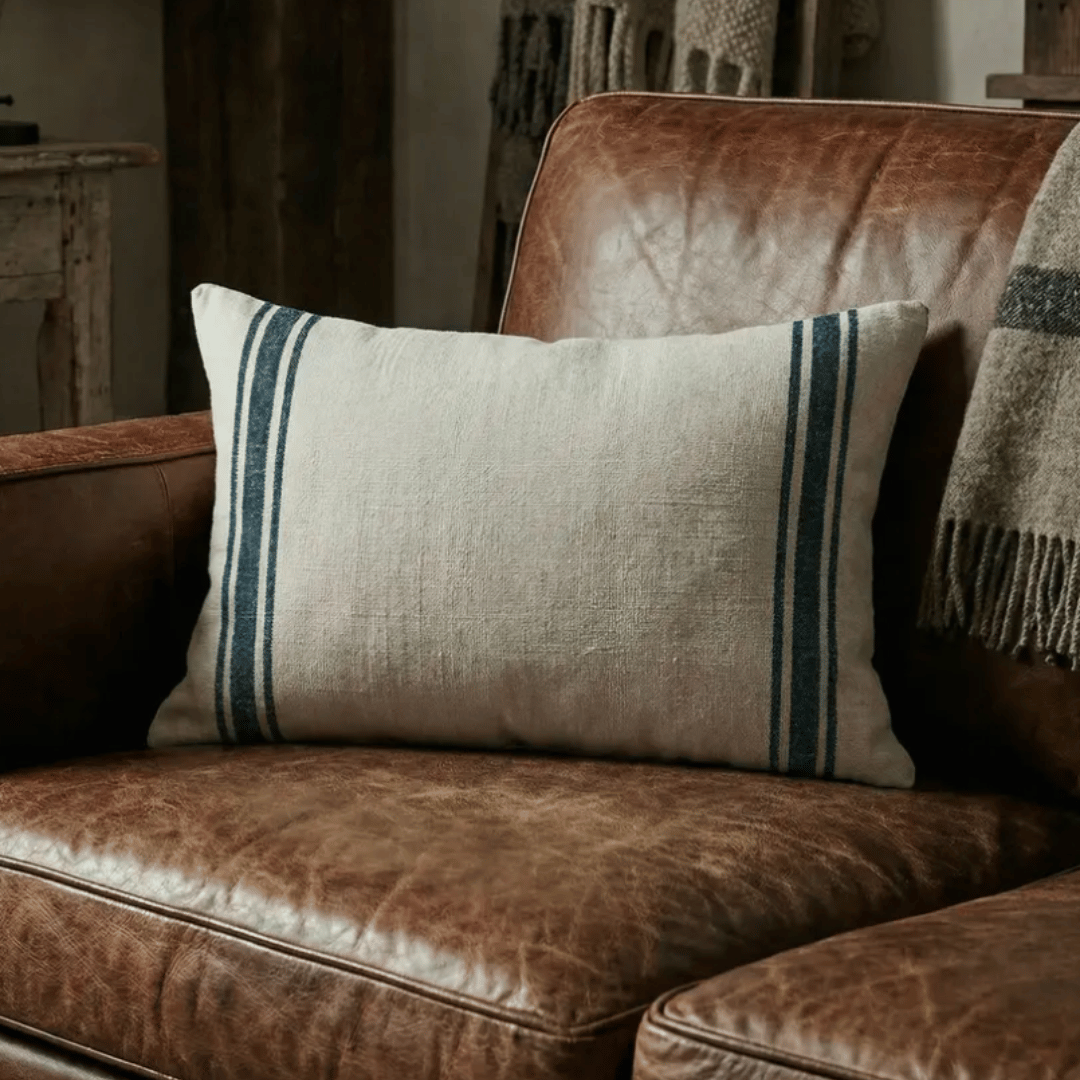 Luberon Rectangle French Grain Stripe Cushion styled on leather couch - Blue denim Stripe
