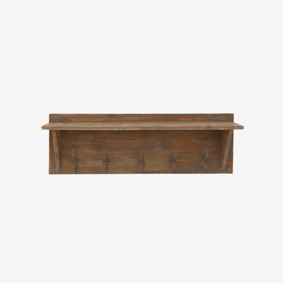 Close-up of rustic wooden shelf showing weathered finish, ledge and iron hooks.