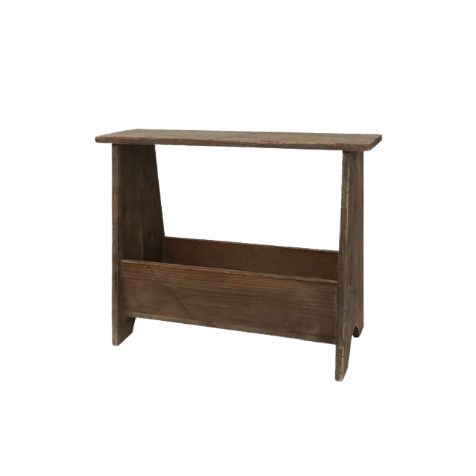 Close-up of weathered wood grain on compact stool with storage space beneath seat.