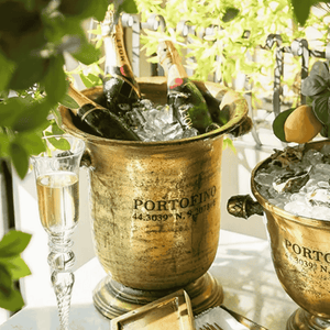 Portofino Tall Champagne Bucket in antique gold with chilled champagne bottles