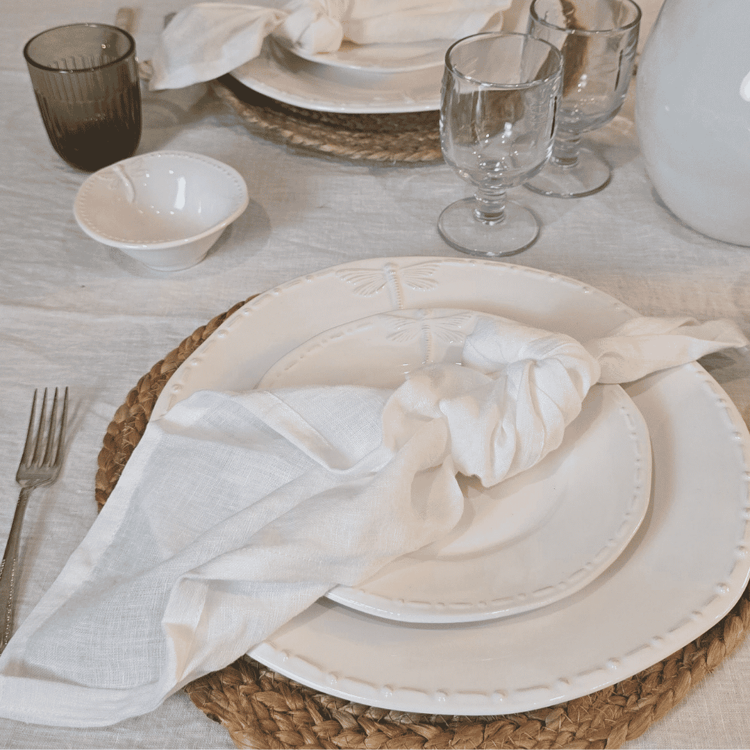 French Flax Napkin White - Place setting with a red rose on a white plate, surrounded by cutlery and a woven placemat.