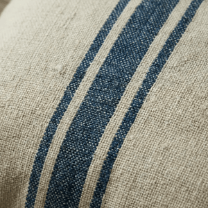 Close-up of a woven French Grain Stripe Cushion.  Natural beige linen-like base and two vertical dark blue stripes.