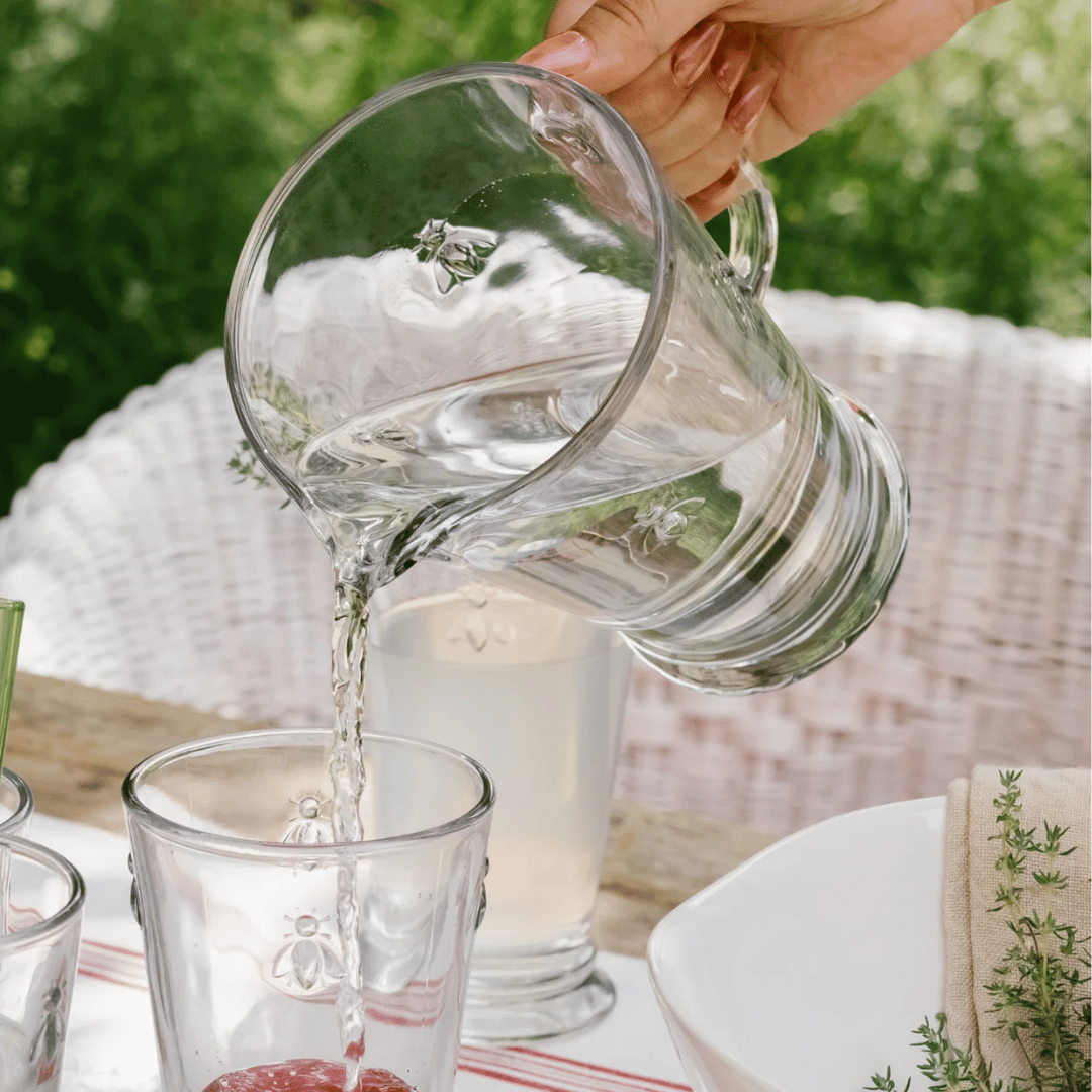 La Rochere Bee Pitcher - Water Jug pouring water into Long Bee water glasses