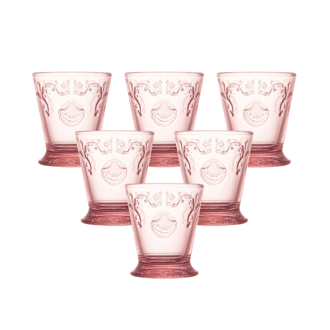 Six French pink glasses by La Rochere. Versailles tumblers with ornate embossed floral and crest motifs.