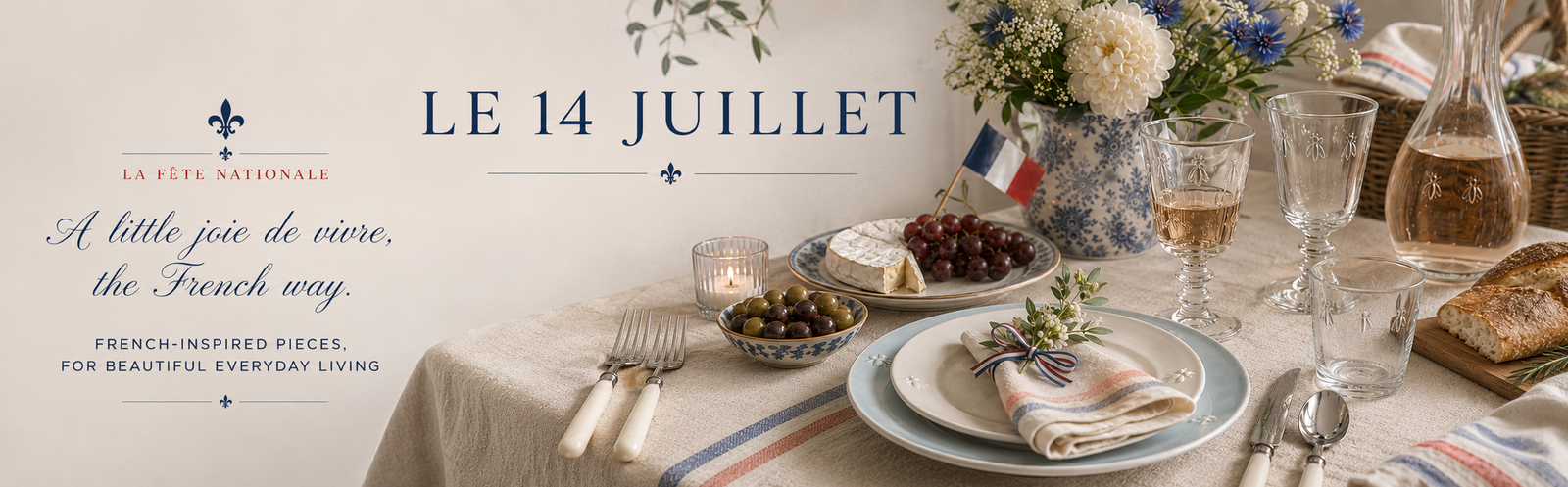 A styled dining table scene with plates, glasses, flowers, and food on a beige tablecloth, with French text reading 'LE 14 JUILLET' and 'A little joy de vivre, the French way.'.
