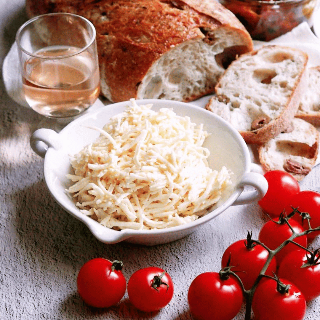 Small White Provence Bowl filled with shredded cheese with bread wine and tomatoes