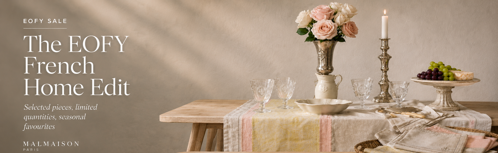 Dining table setting with flowers, candles, and glasses on a neutral background with 'The EOFY French Home Edit' text.