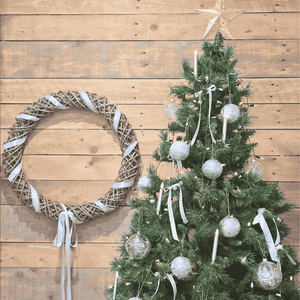 Decorated Christmas tree with ornaments and a Kubo Provence Wreath on a timber background