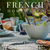 French table setting with bowls, glasses, and bread on a tablecloth.