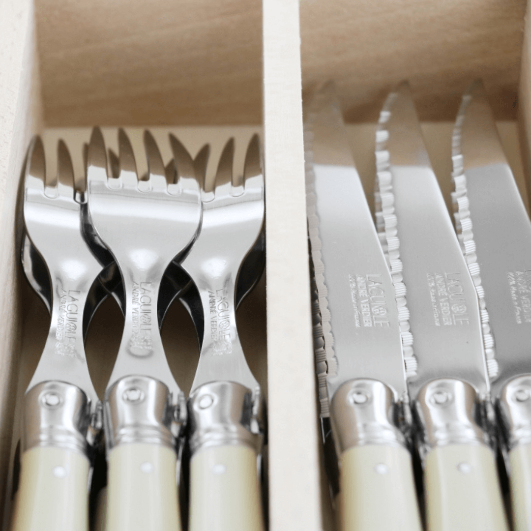 Close up of Knives and Forks from Laguiole Debutant cutlery set in ivory – Beech wood gift box - Authentic French dining set – Malmaison