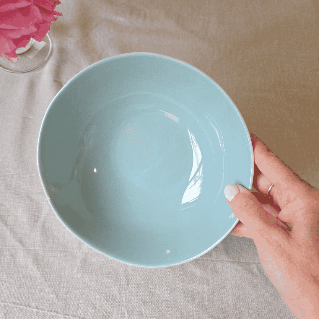Light blue ceramic bowl on a neutral background