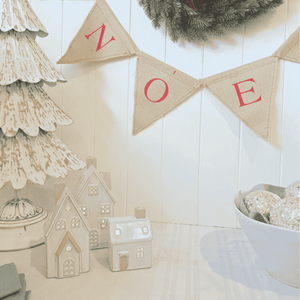 Set of three white ceramic houses beside Étoile de Lune Tree