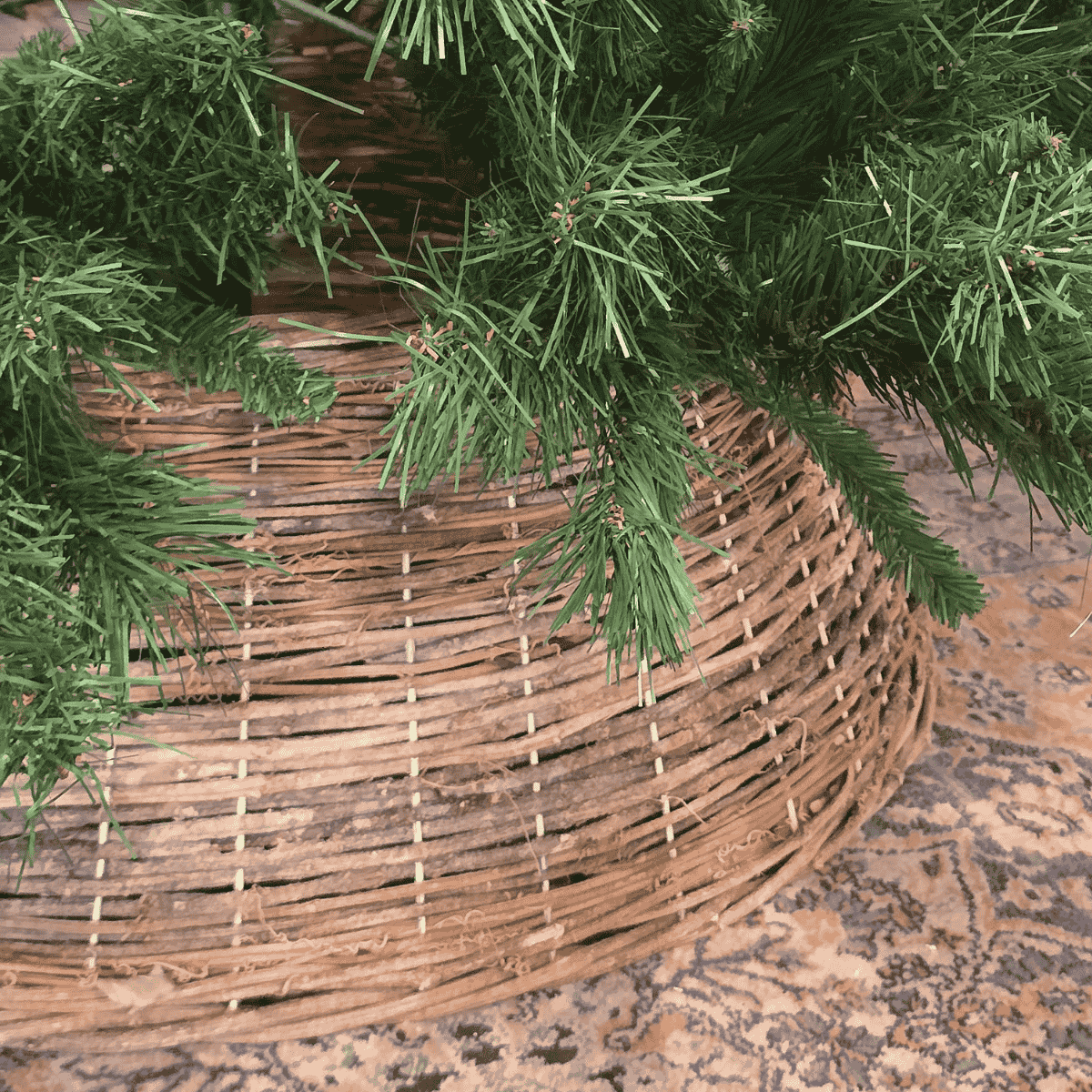 Natural grapevine Christmas  tree skirt styled on patterned rug – Malmaison Noël de Maison