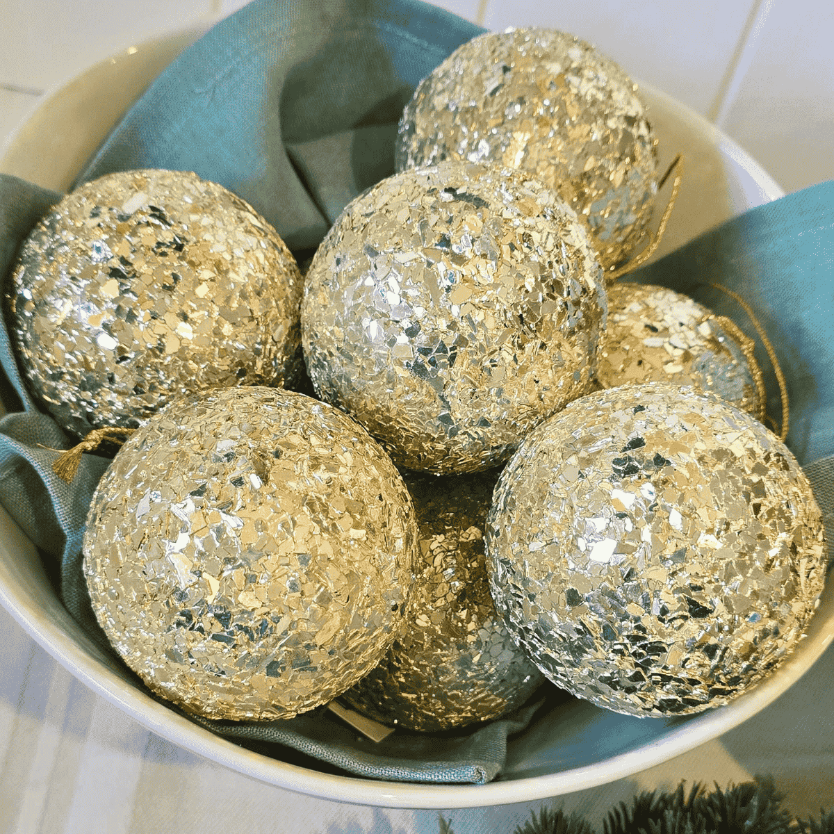 soft gold Champagne Christmas baubles in bowl with French holiday elegance