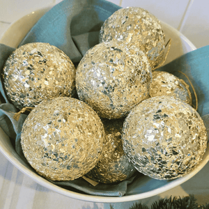 soft gold Champagne Christmas baubles in bowl with French holiday elegance