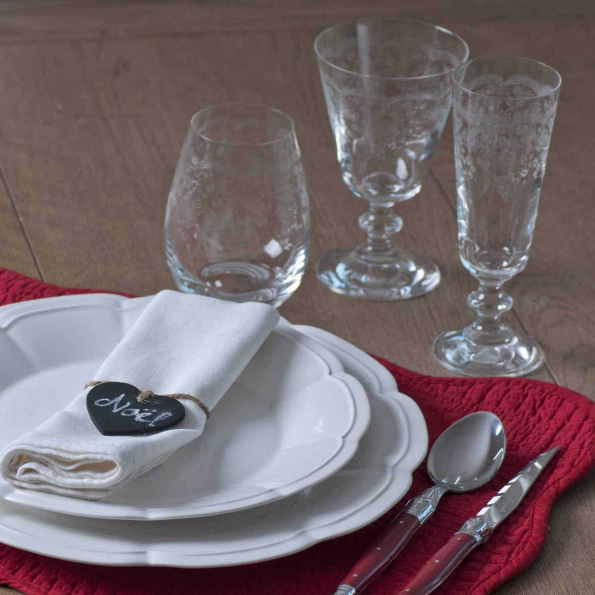Elegant champagne flute with matching wine glass and stemless wine glass with table setting.