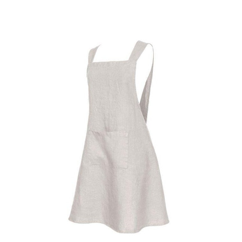 A natural color French linen Kyoto apron with a large front pocket and cross-back design.