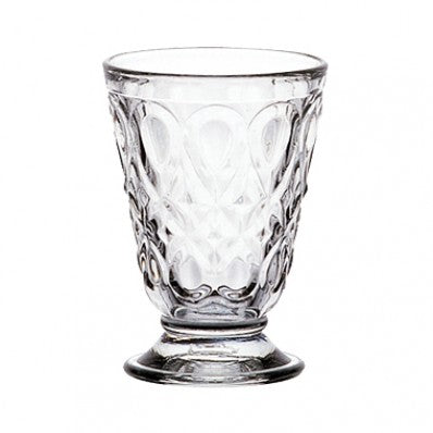 A clear glass Lyonnais tumbler with a teardrop shape and intricate floral pattern.